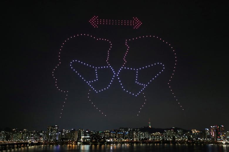 Drones fly over the Han river showing messages to support the country, as measures to avoid the spread of the coronavirus continue, in Seoul, South Korea.   Yonhap via REUTERS